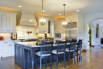 Kitchen with Center Island and View of Hallway