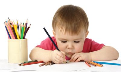 Cute child draw with color crayons