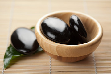 zen stones in wooden bowl. spa background