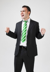 successful businessman with his arms raised