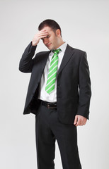 stressed businessman with his hand to his head