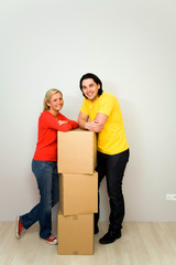 Fototapeta na wymiar Couple leaning on packing boxes