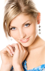 Close-up studio portrait of a beautiful fresh blond girl with pe