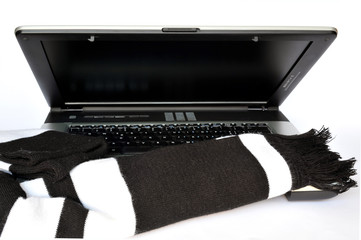 Open laptop with black & white scarf