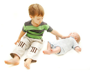 toddler and baby over white