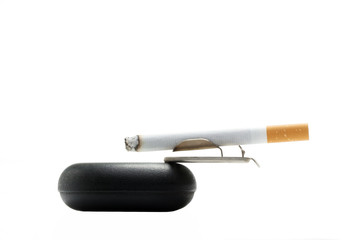 Cigarette on ashtray over white