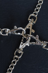 Fototapeta na wymiar Close-up of steel locked chains on dark background