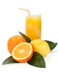 Fruits with green leaves and glass of juice