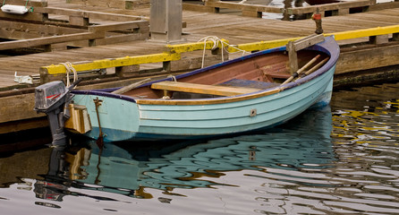 Fototapeta na wymiar Small Blue Boat at a Pier