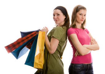 Two beautiful girls with shopping bags. Isolated on white.