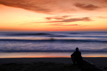 man alone watching sunset - 12833459