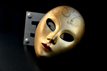 Golden mask in the darkness.