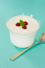 macro image of yogurt and fruit in a glass jar