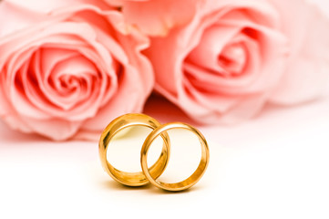 Roses and wedding ring isolated on the white