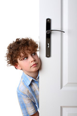 Boy peeking behind door
