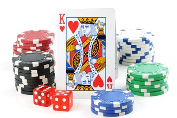 chips, playing cards and dice on the white
