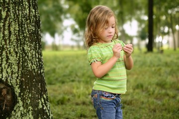 Little toddler girl playing on the park
