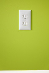 white electric outlet mounted on green wall