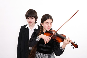 The girl plays for the boy on a violin