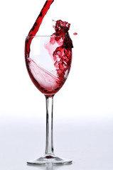 Red wine poured on glass