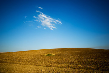 small hill with blue sky and white cloud