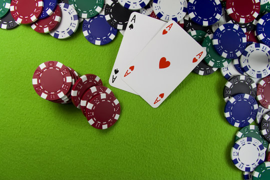 Pair of aces over poker chips