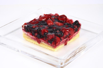fruit cake in glass plate on white background