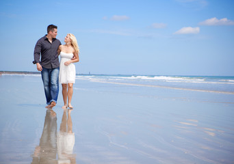 Couple at the beach walking and talking