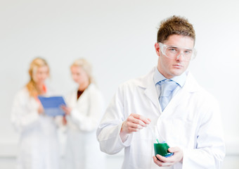 Chemist  with collegues in the background