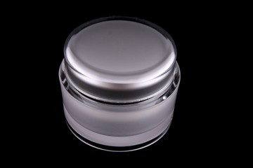 White cosmetic container isolated on black background