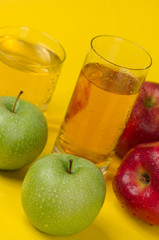 Juicy red and green apples on a red background
