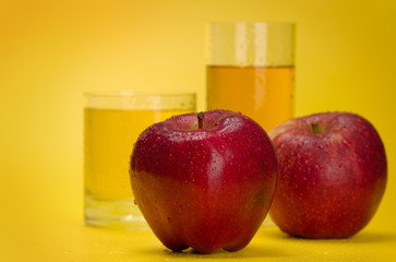 Juicy red apples on a yellow background