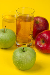 Juicy red apples on a yellow background