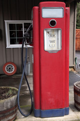 Old antique gas pump in front of auto business