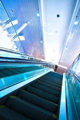Fototapeta premium Escalator in blue corridor