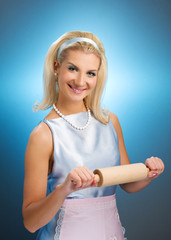 Happy housewife with rolling pin