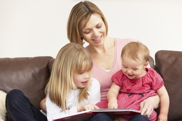 Fototapeta premium Mother And Daughters Reading Book