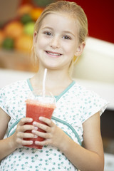 Obraz na płótnie Canvas Young Girl Drinking A Berry Smoothie