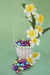 Easter egg basket decorated with flower on green