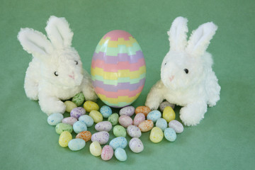 Easter bunnies with striped puzzle egg.