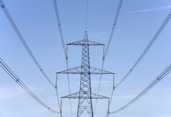 Electricity Pylons Against A Blue Sky