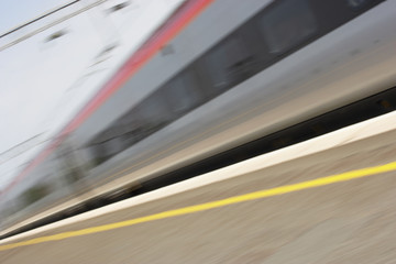 Fototapeta na wymiar Train Travelling Past Platform