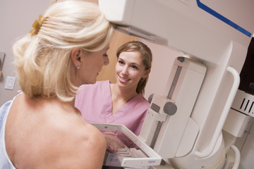 Nurse Assisting Patient Undergoing Mammogram - obrazy, fototapety, plakaty