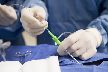 Surgeon Inserting Tube Into Patient During Surgery - obrazy, fototapety, plakaty
