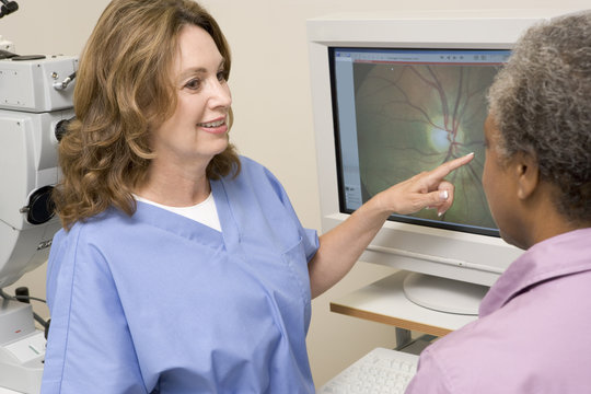 Nurse Explaining Eye Exam Results To Patient
