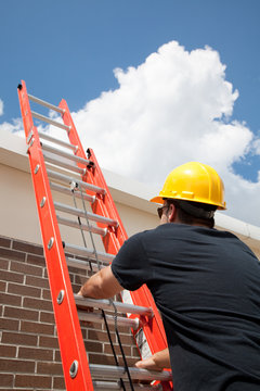 Construction Worker Climbs Ladder
