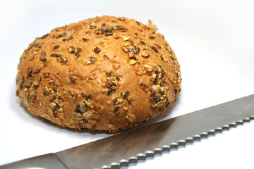 A whole-grain roll with a measuring tape.
