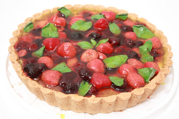 pie with ripe strawberry, blackberry and mint