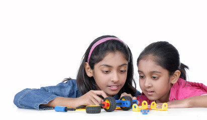 two young girls playing with mechanical blocks