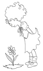 Bimba che guarda un fiore